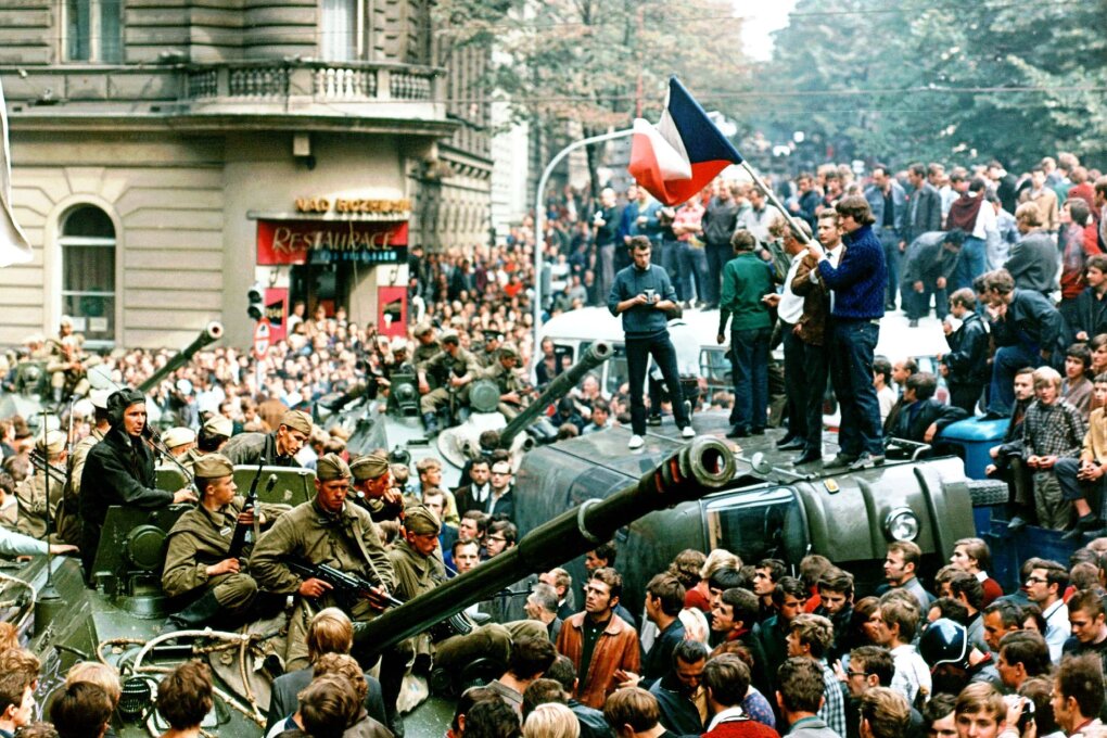 Czech youngsters holding Czechoslovakian flags stand atop of an overturned truck as other Prague residents surround Soviet tanks in downtown Prague on Aug. 21, 1968, as a Soviet-led invasion by the Warsaw Pact armies crushed the so-called Prague Spring reform in former Czechoslovakia 30 years ago. (AP Photo/Libor Hajsky/CTK)